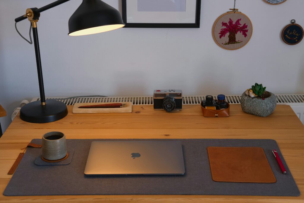 A minimalist flat-lay of a designer’s workspace: laptop, sketchpad, tablet